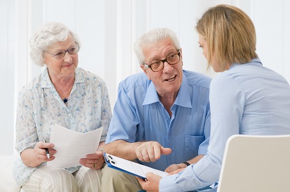 Business agent planning with a retired couple their future investments.