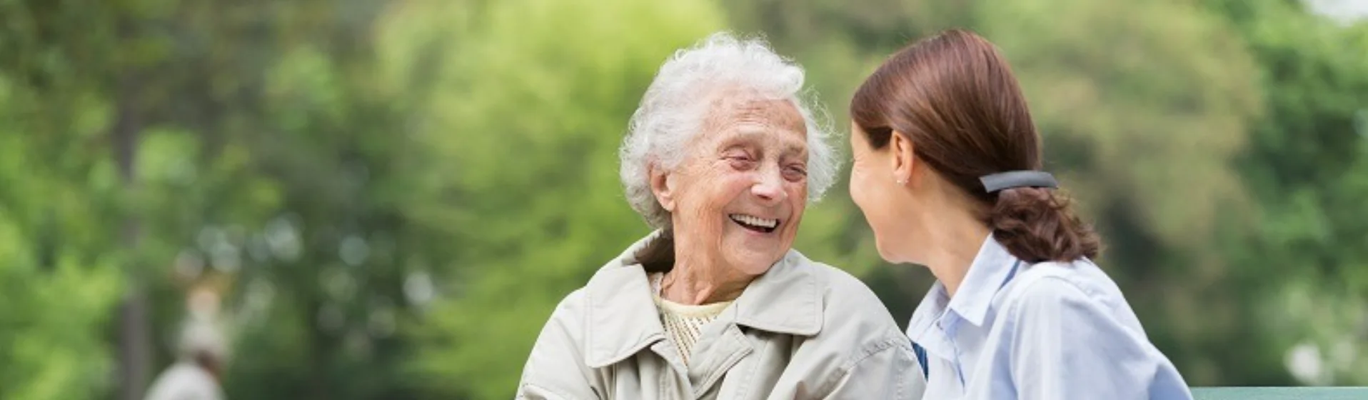 Senior woman with caregiver in the park